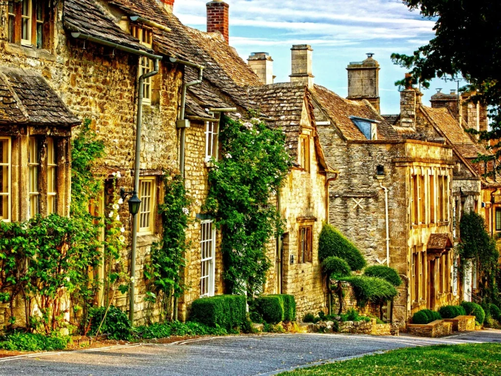 a stone buildings with trees and bushes on the side