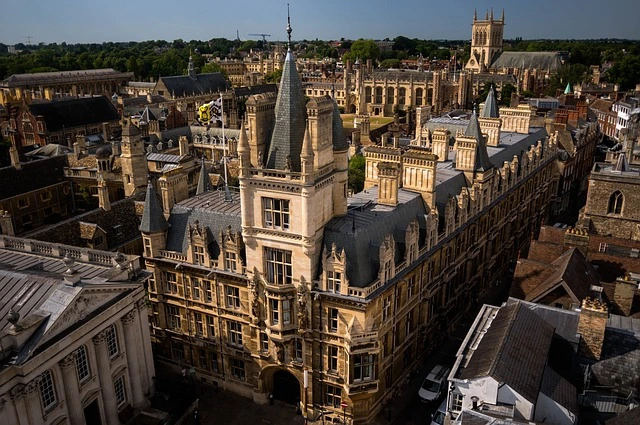 a large building with a steeple and a city in the background